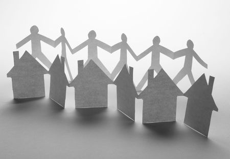 close up of houses and people cut out of paper on white background の写真素材