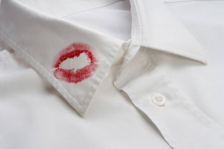 close up of white shirt and red lipstick on itの写真素材