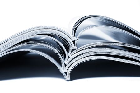 close up of stack of magazines on white backgroundの写真素材