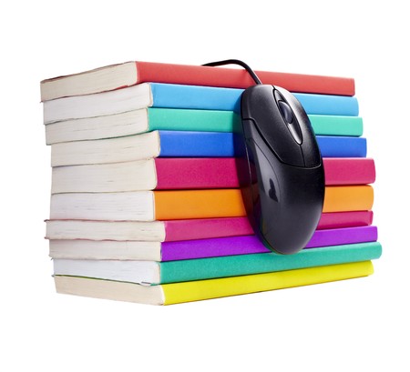 close up of stack of colorful books and computer mouse on white backgroundの写真素材