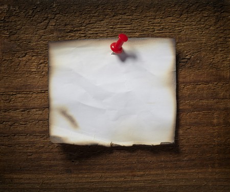 close up of grunge note paper on wooden backgroundの写真素材