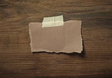 close up of grunge note paper on wooden backgroundの写真素材