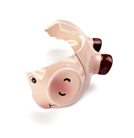 close up of a broken piggy bank on white backgroundの写真素材