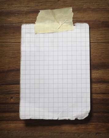 close up of grunge note paper on wooden backgroundの写真素材