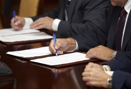 close up of businessman hands signing contract