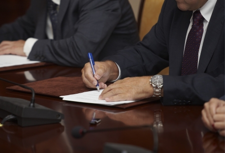 close up of businessman hands signing contractの写真素材