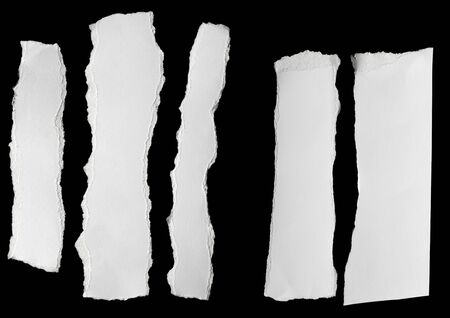 collection of  white ripped pieces of paper on blackの写真素材