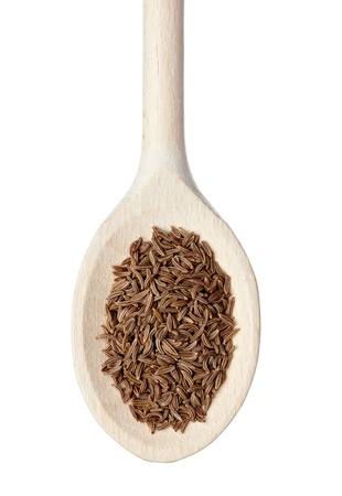 close up of caraway in wooden spoon on white backgroundの写真素材
