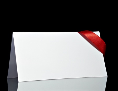 close up of  card note with  ribbon on black background の写真素材