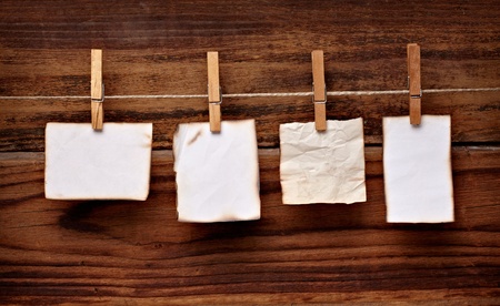 close up of  a note paper and clothes peg on a wooden backgroundの写真素材