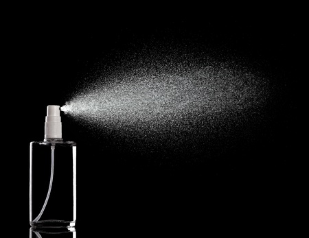 close up of a spray bottle drops on black background close up of a spray bottle drops on black background
