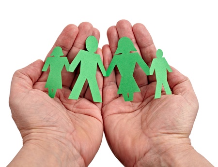 closeup of chain of paper people in hands on white backgroundの写真素材