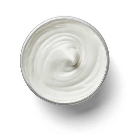 close up of a white beauty cream or yoghurt on white background with clipping path