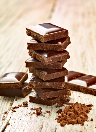 close up of chocolate pieces on  wooden backgroundの写真素材