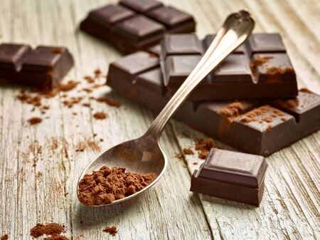 close up of chocolate pieces on  wooden backgroundの写真素材