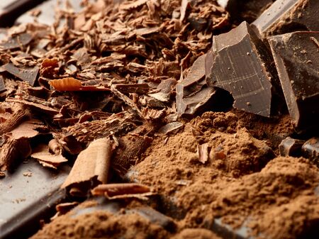close up of chocolate pieces on  wooden background
