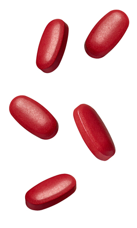 collection of various red pills on white backgroundの写真素材