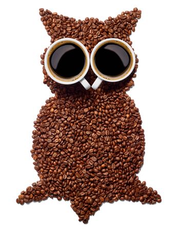 close up of a coffee cup with coffee beans and an owl shape on white backgroundの写真素材