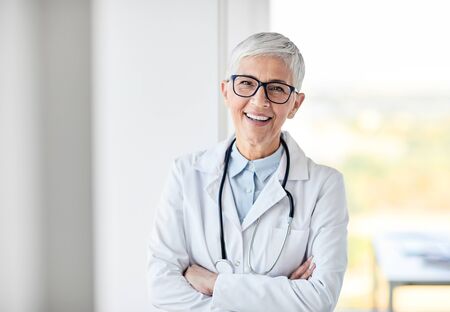 portrait of a senior female doctor in a white coat with a stethoscopeの写真素材
