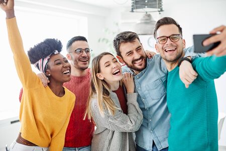 young people friends taking a selfie during a party or gathering indoors