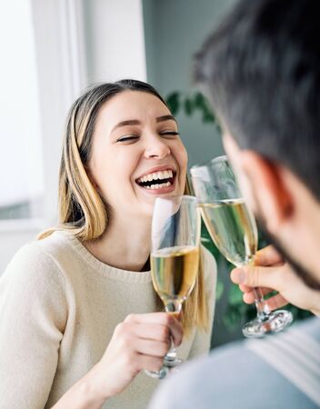Young couple toasting with champagne, portrait of a happy young woman girlの写真素材