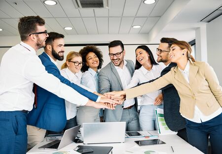 Portrait of a group of young business people in the office. Unity and teamwork business concept