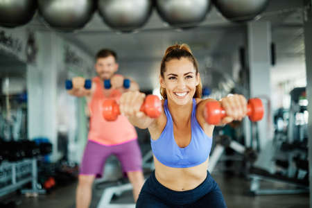 Happy healthy fit people at the gym exercisingの写真素材