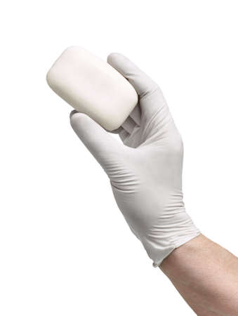 close up of hand and gloves holding a soap on white background
