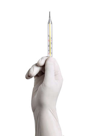 close up of a hand with white latex protective gloves holding a thermometer on white backgroundの写真素材