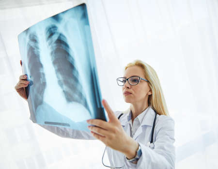 Doctors looking  at a x-ray image in their hospital office