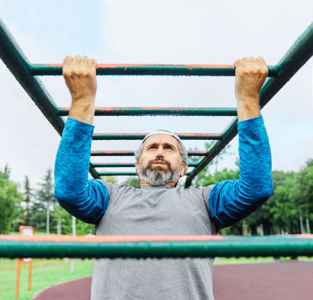 portrait of a senior man exercising and running outdoors