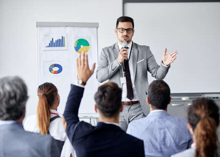 Young busnessman having a speech by a whiteboard during a conference business meeting in an office. Business conceptの写真素材