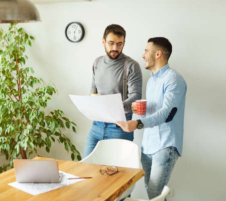 Portrait of two young business people having a meeting in the office. Teamwork and success conceptの写真素材