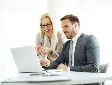 Business people having a meeting in the office over laptop. Teamwork and success concept