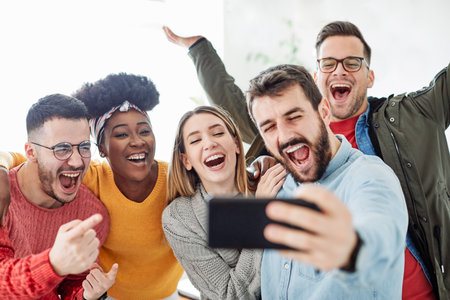 Happy young people having fun together taking selfie