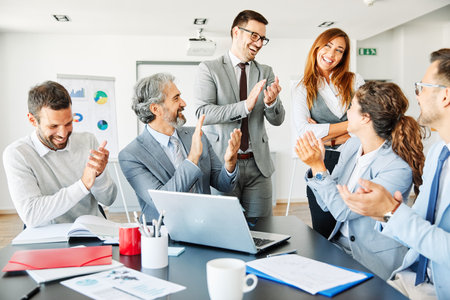 Successful businesspeople applauding to colleague during a meeting in an office. Business conceptの写真素材