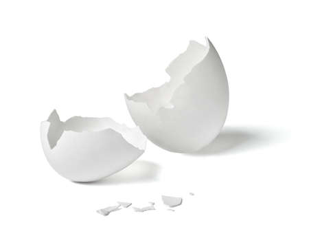 Close up of a broken white eggshell on white backgroundの写真素材