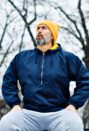 Active senior man running jogging exercising in the park