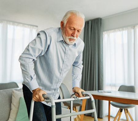 Portrait of a lonely senior man using walker assistanece at home or nursing homeの写真素材