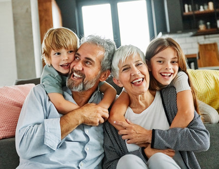 Portrait of grandparents and grandchildren having fun together at homeの写真素材