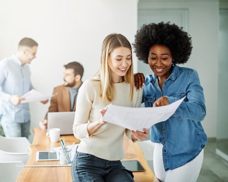 Portrait of two young business people having a meeting in the office. Teamwork and success conceptの写真素材