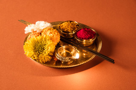 Pooja Thali and Flower Decoration made using marigold or zendu flowers and mango leaves. Indian...