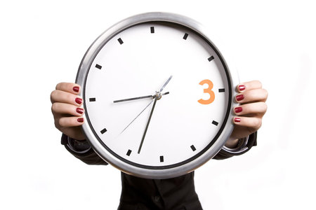 business woman holding giant alarm clock