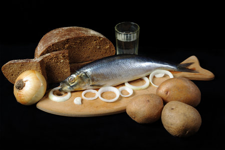 "Pickled herring, onion, potato and bread.Black background"の写真素材