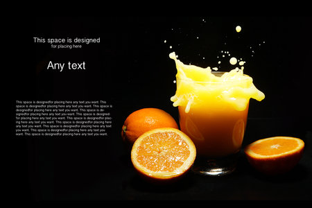 Orange juice splash on black backgroundの写真素材