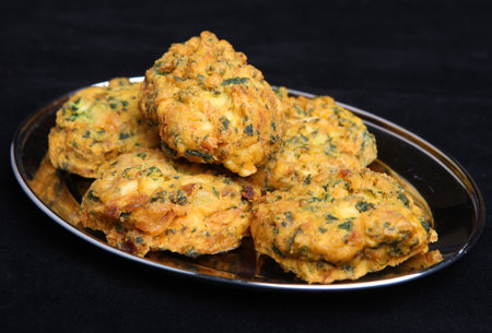 Indian vegetable pakora made from spinach, potato, cauliflower and onion.