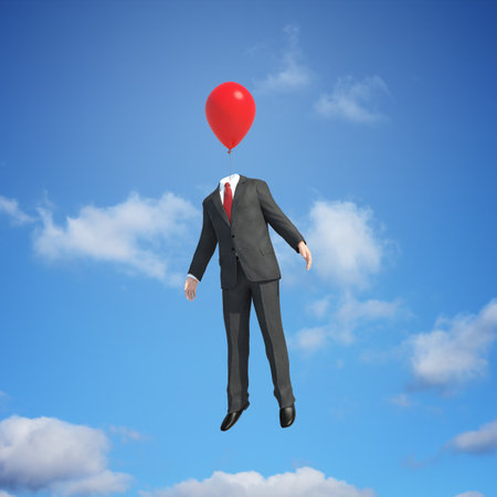 A man in a suit with a balloon head flying high in the skyの写真素材
