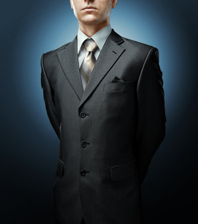 businessman with hands behind standing with command poseの写真素材