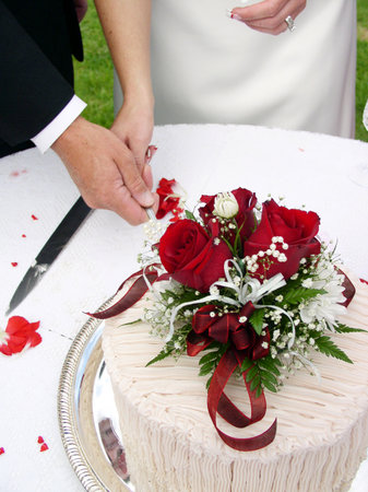 Bride and groom cutting the wedding cakeの写真素材
