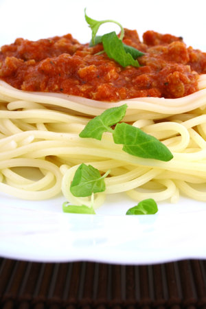Freshly cooked plate of spaghetti with fresh green herbs.の写真素材